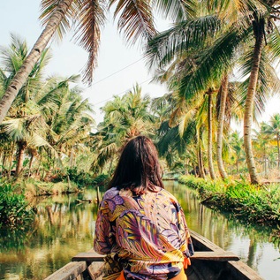 Traveler enjoys peaceful Kerala backwater tour adventure