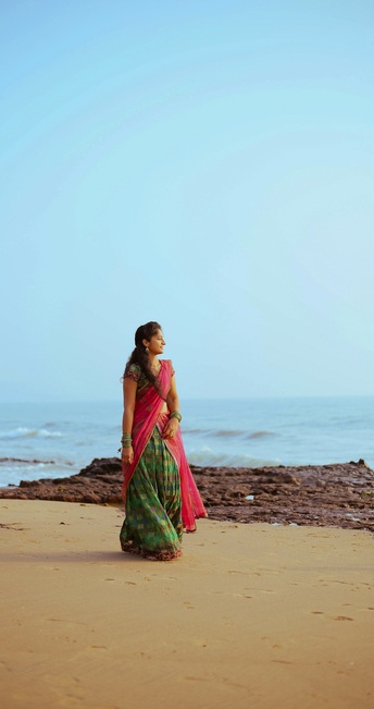 Traveler walks on serene beach during coastal holiday tour